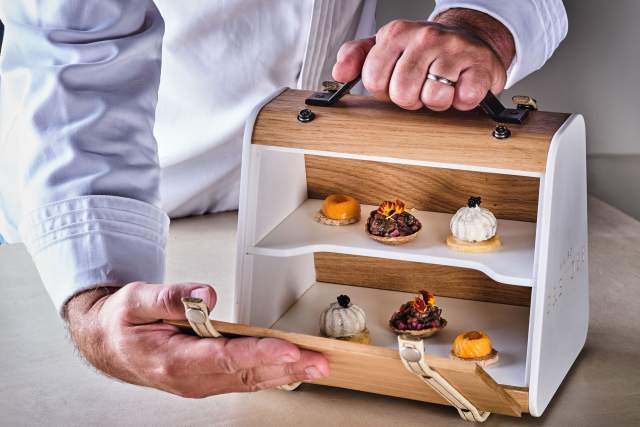 Présentation de mignardises sur présentoir en bois à deux niveaux, service gastronomique – Restaurant Gastronomique Hauts-de-France